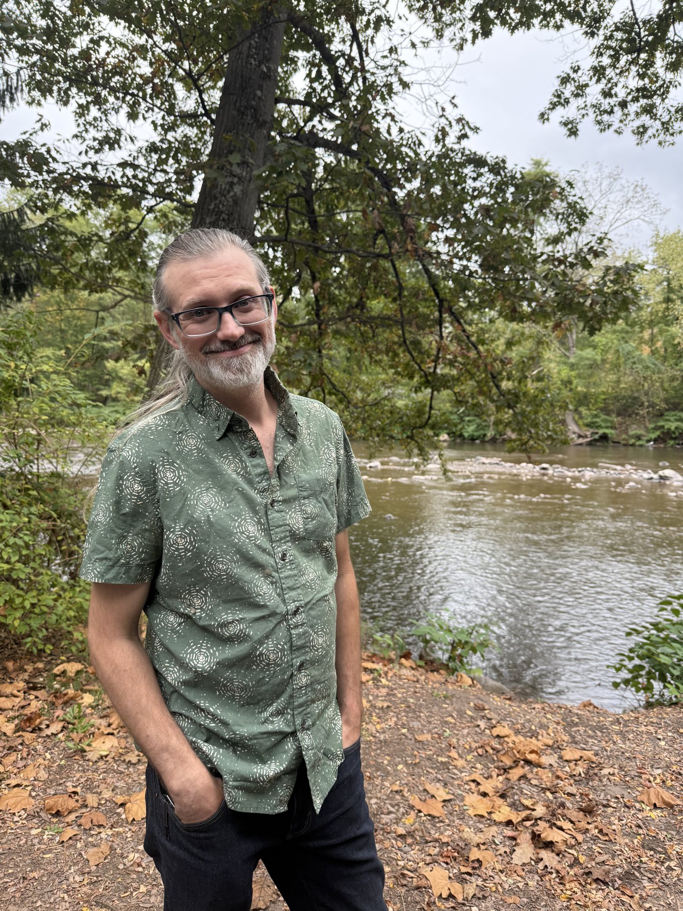 Portrait of Steve Plekan smiling beside a river